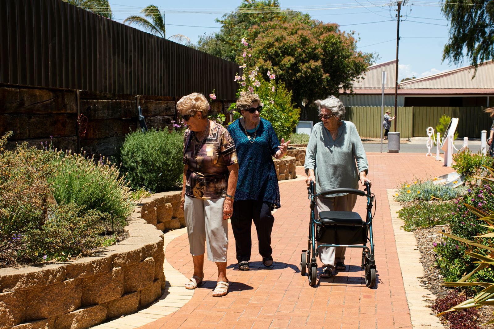 Three older women enjoying a walk together outdoors