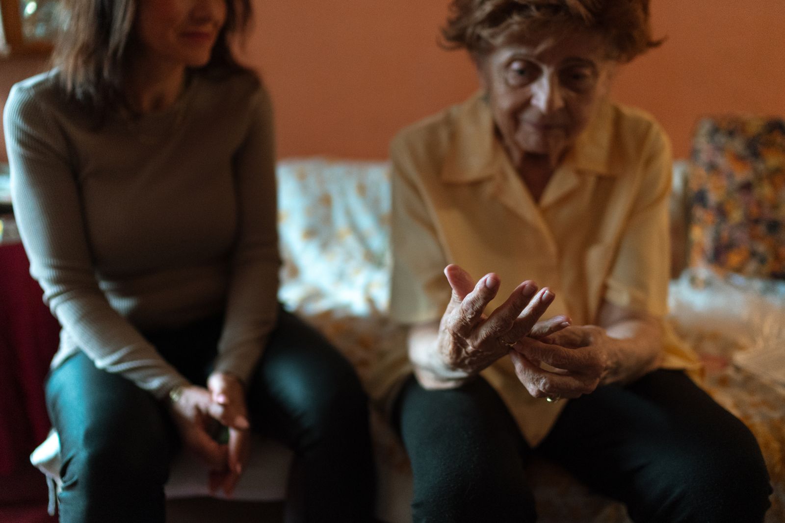 An older woman talking with a companion during a home visit