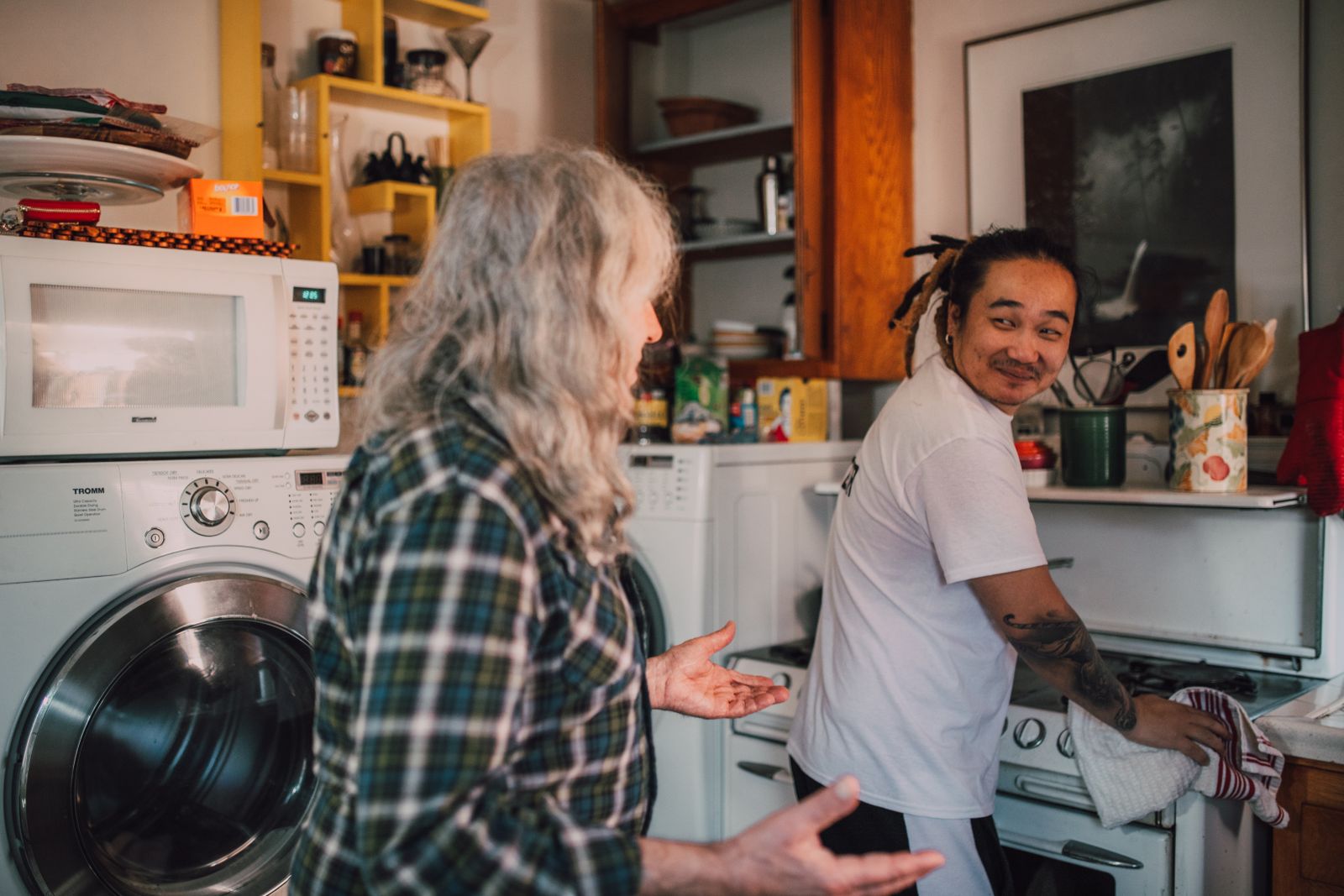 Caregiver helping an older adult with household tasks at home